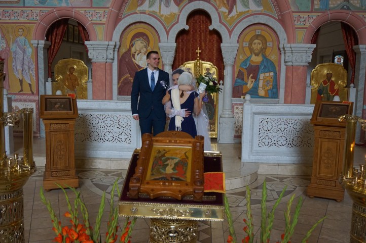 Bridesmaid helping the bride holding