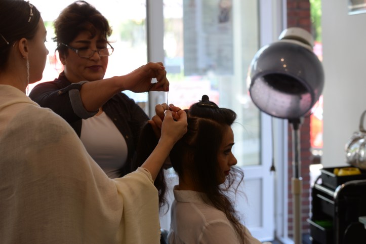 Bridesmaid helping the bride