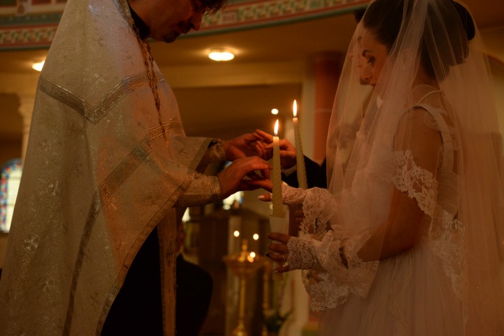 The priest putting on the rings