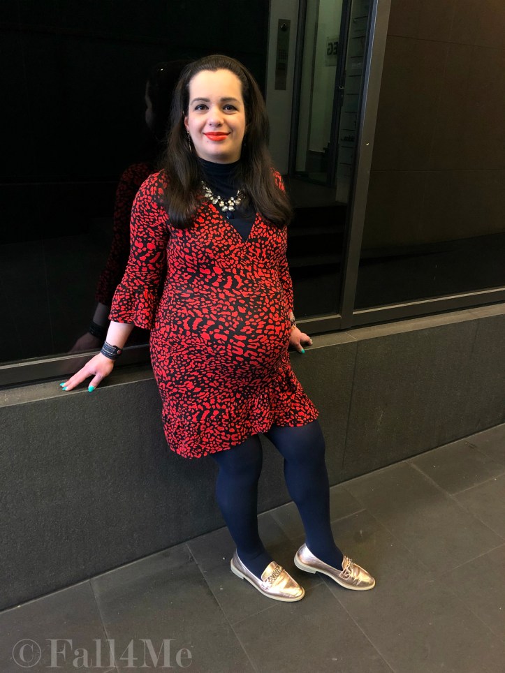 An orange dress worn with navy blue accents