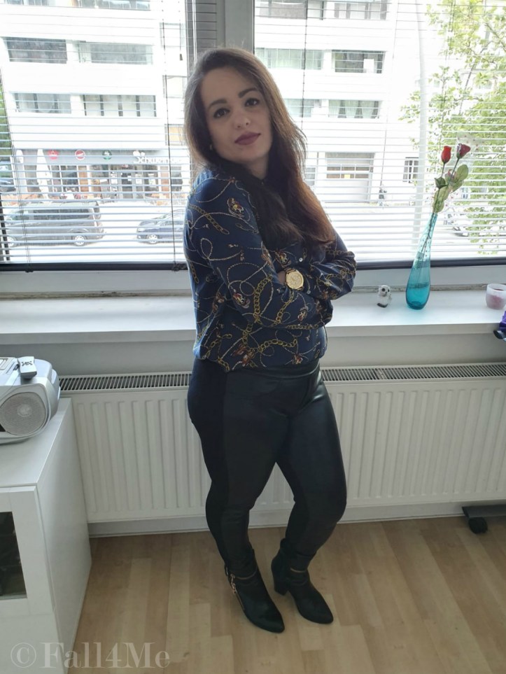 Trendy office chic: A trendy blouse with skinny black pants and boots.