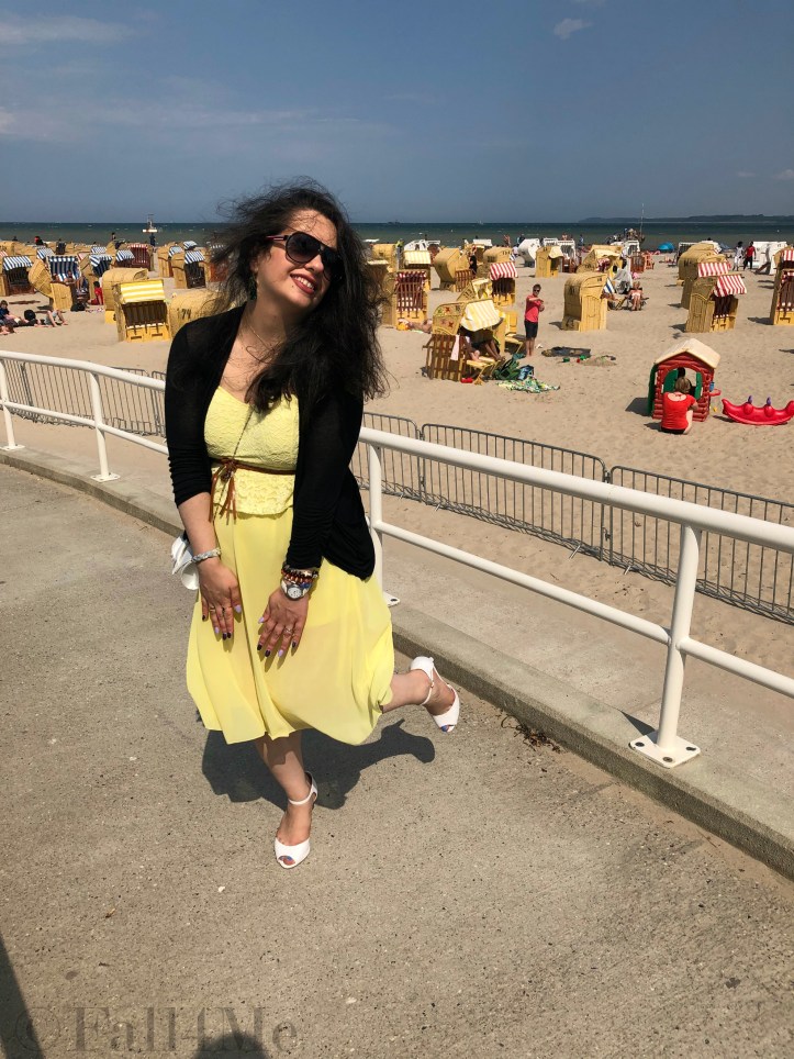 A dress in lemon yellow elegantly combined with black and white and green accents