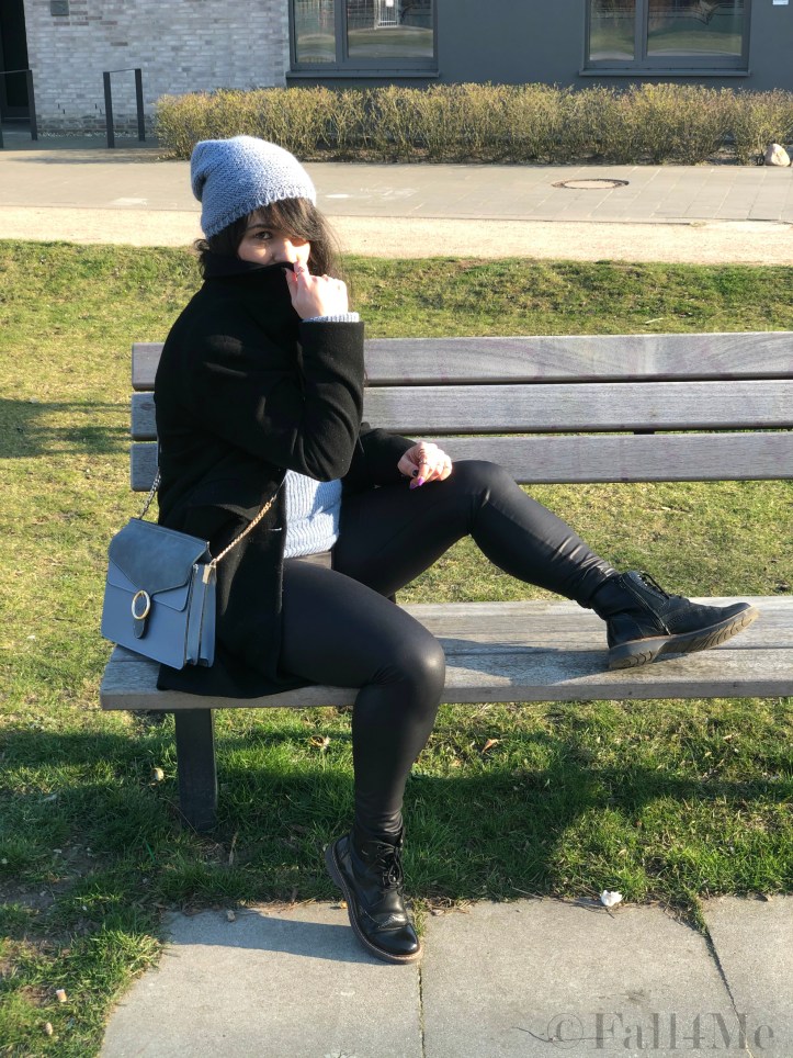 Steel-blue knit mixed with black leather and wool.