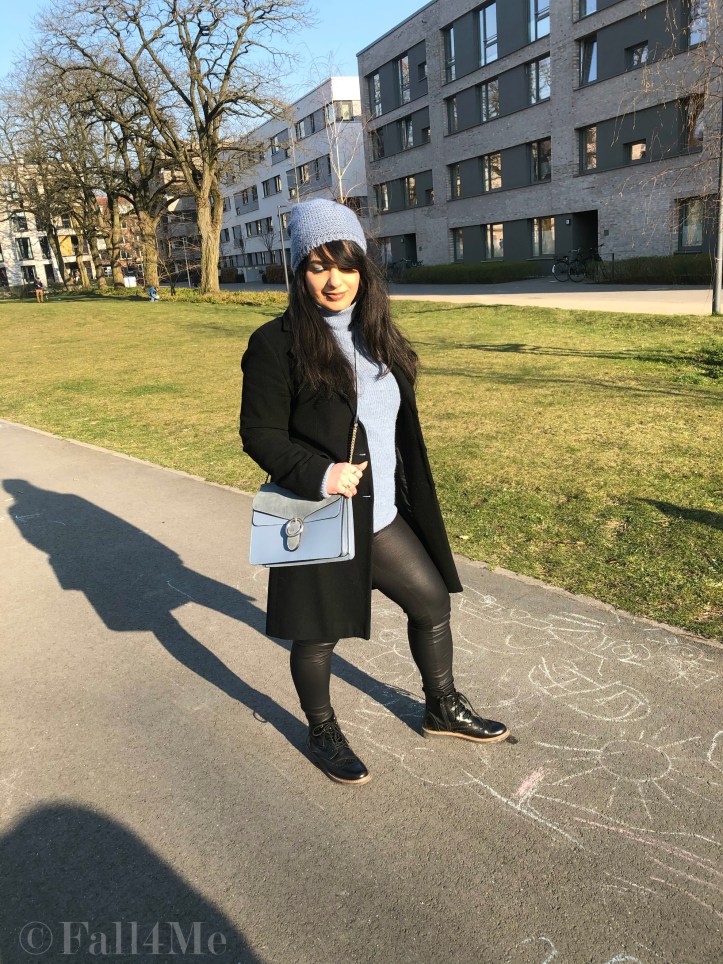 Steel-blue knit mixed with black leather and wool.