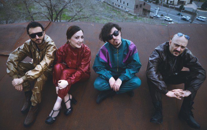 The members of the Nemra band sitting on a rooftop