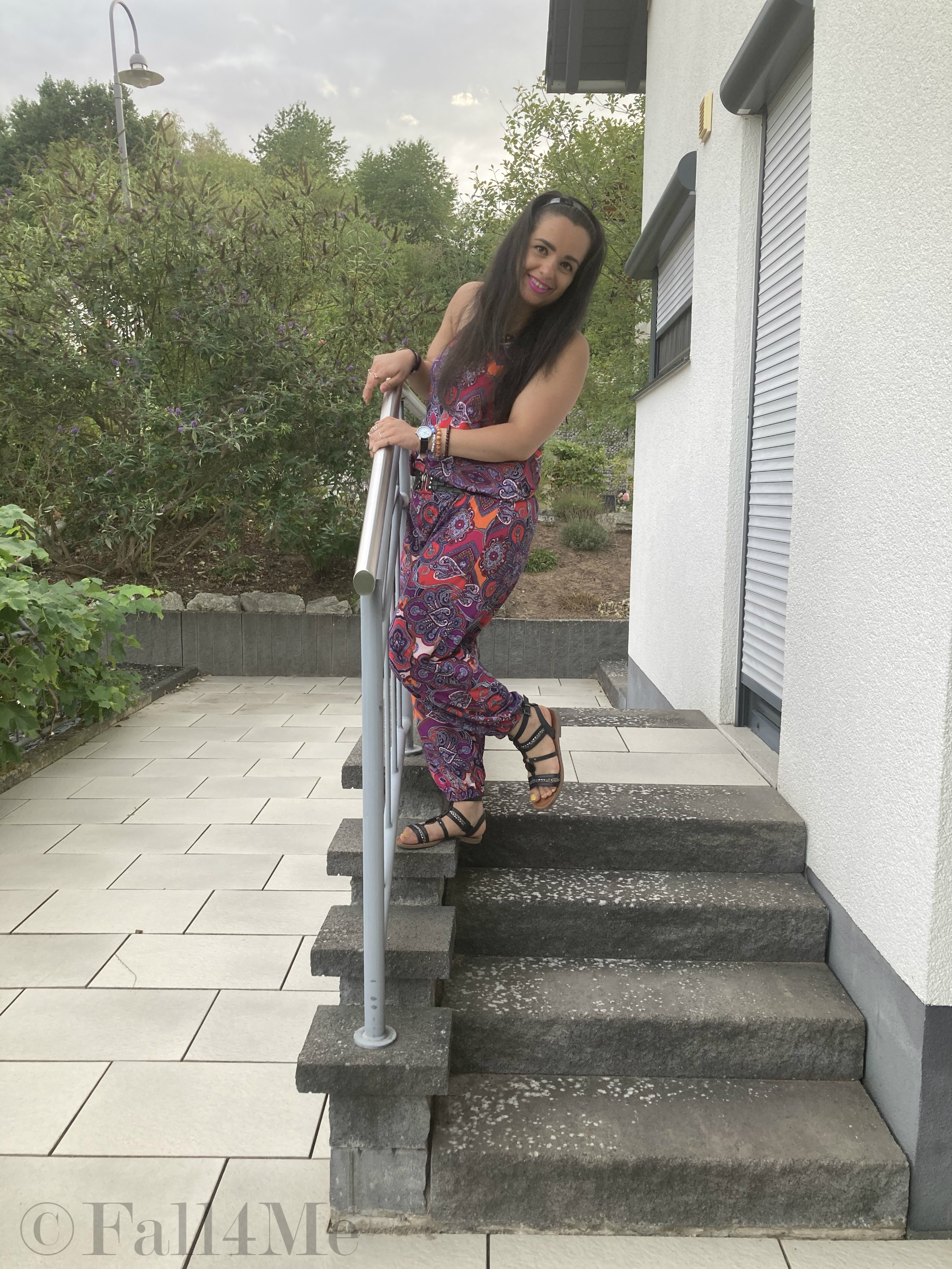 A jumpsuit in shades of raspberry combined with black.