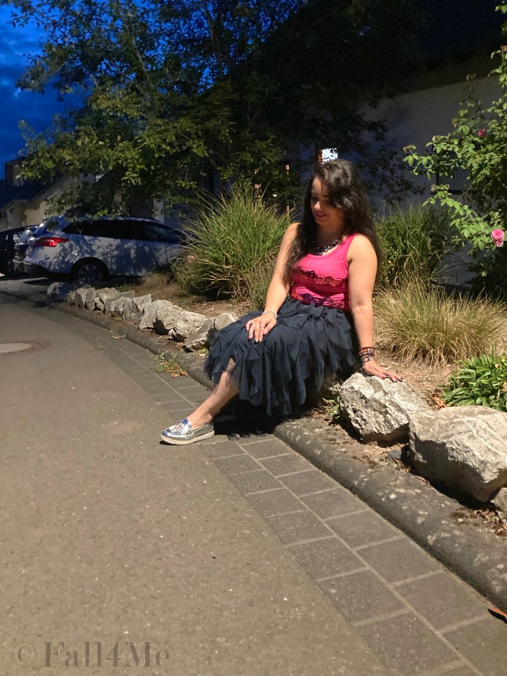 A navy blue tulle skirt combined with a pink sequins top.