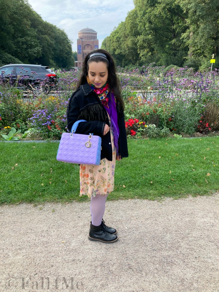 Combat boots worn with a summer dress, combined with a granny bag and fringes.