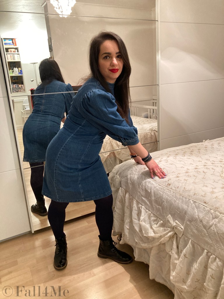 A denim dress with balloon sleeves combined with blue tights and combat boots.