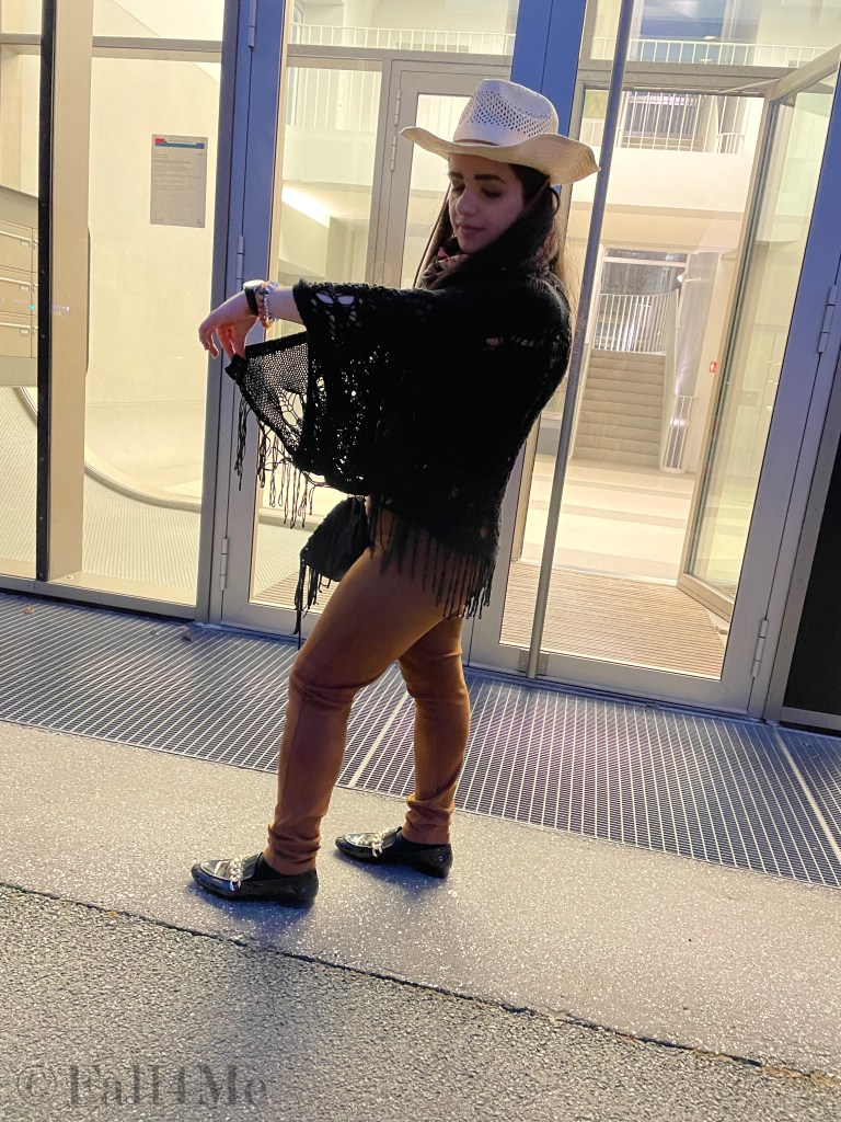 Fringes worn in the western style with a big floral colorful silk scarf.