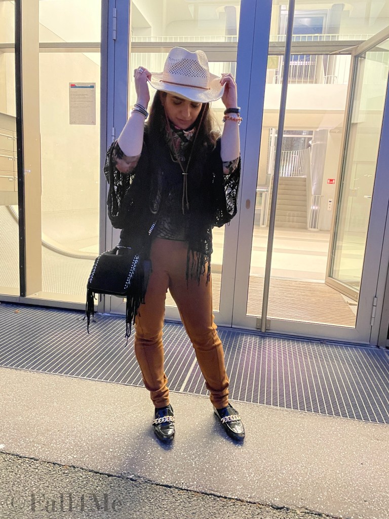 Fringes worn in the western style with a big floral colorful silk scarf.