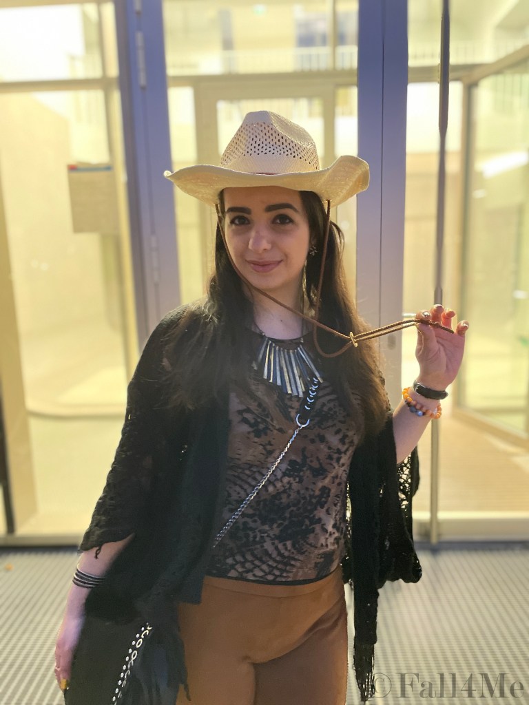 Fringes worn in the western style with a big floral colorful silk scarf.