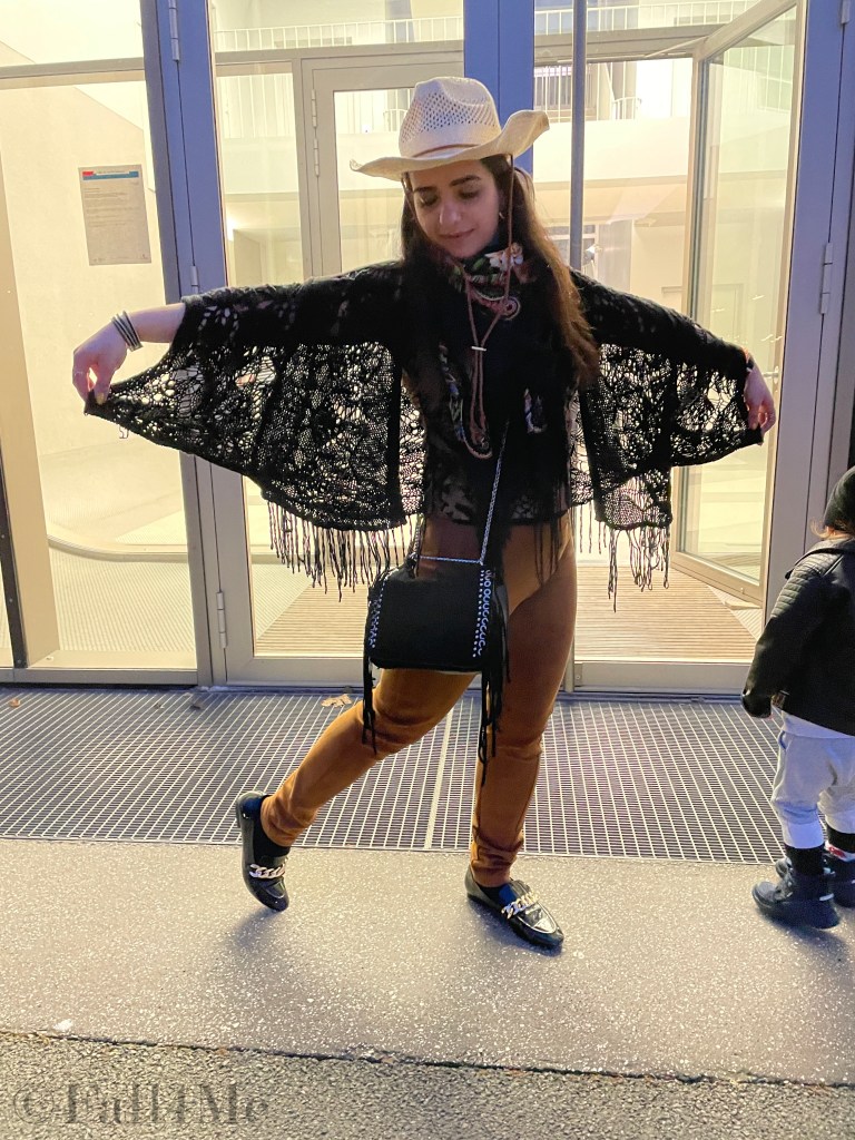 Fringes worn in the western style with a big floral colorful silk scarf.