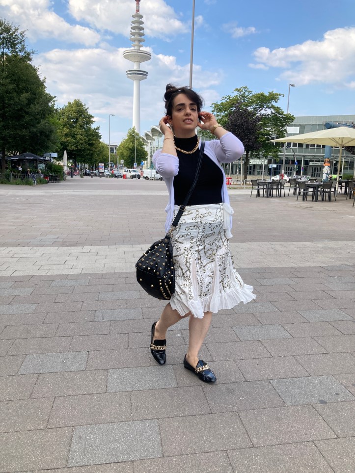 White combined with black contrasts and bold golden jewellery.