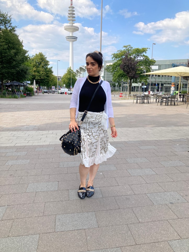 White combined with black contrasts and bold golden jewellery.