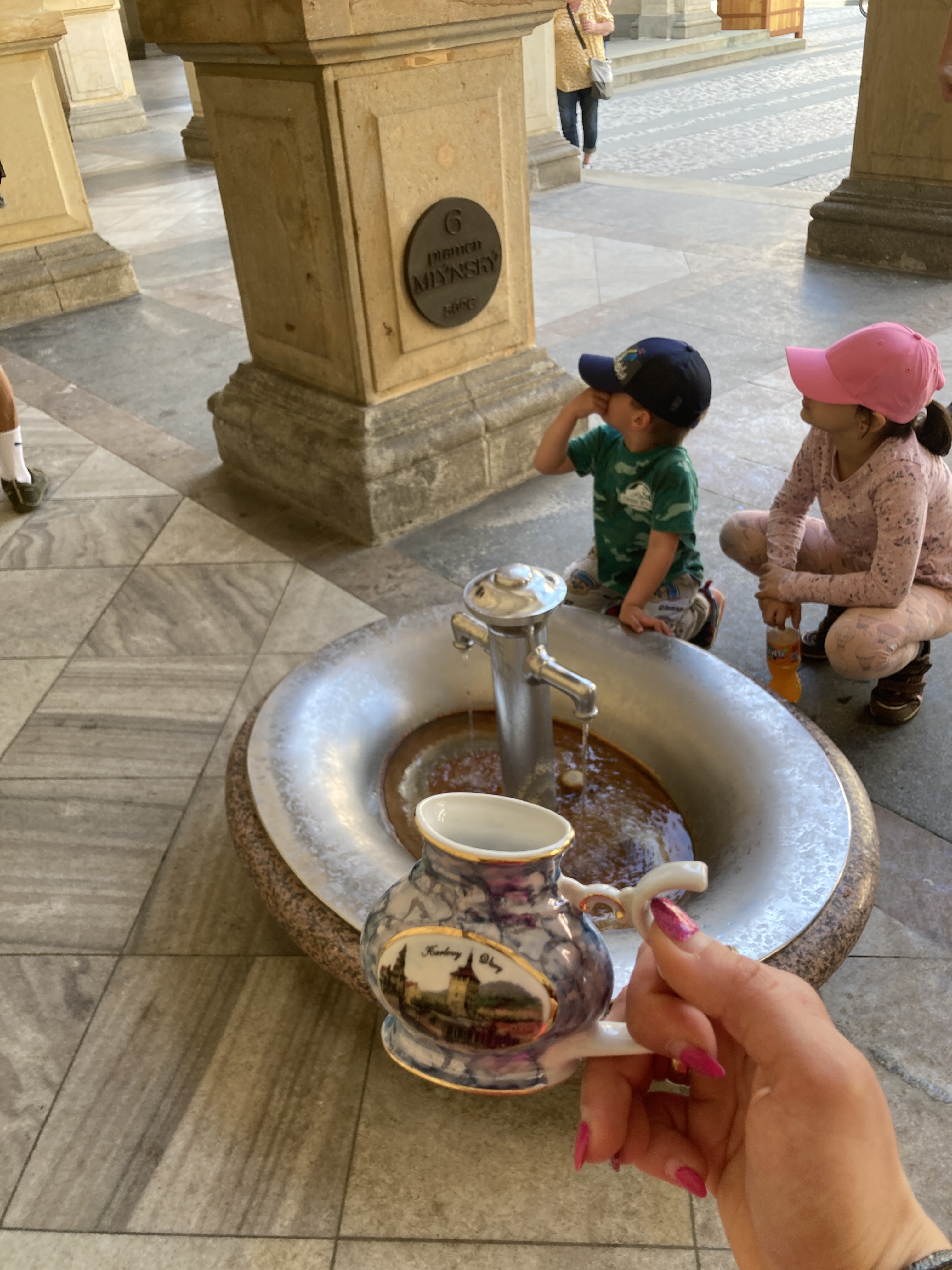 One of the healing sources in Karlovy Vary and a carafe in which you can fill and drink the water from.