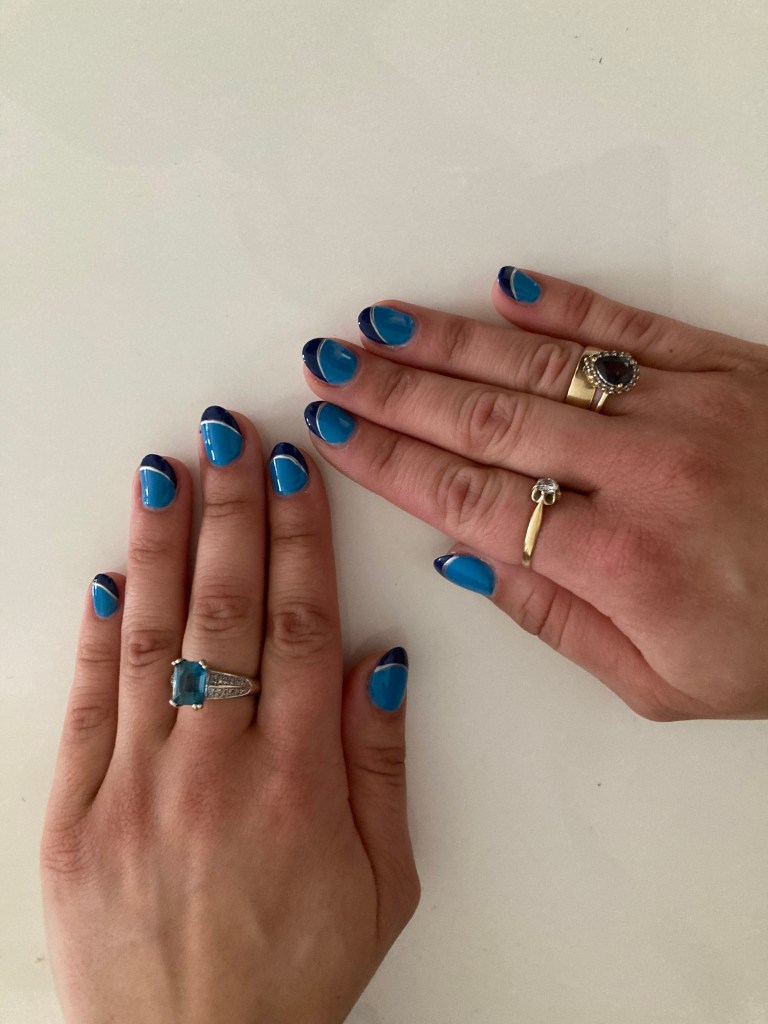 Nails in two different shades of blue with a silver line separating them.