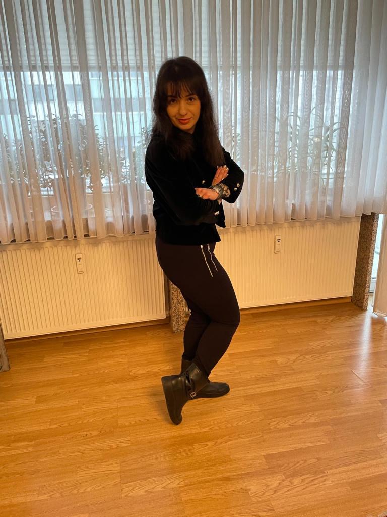 A basically black look based on the puffed shouldered blazer highlighted with green for the make-up trend.