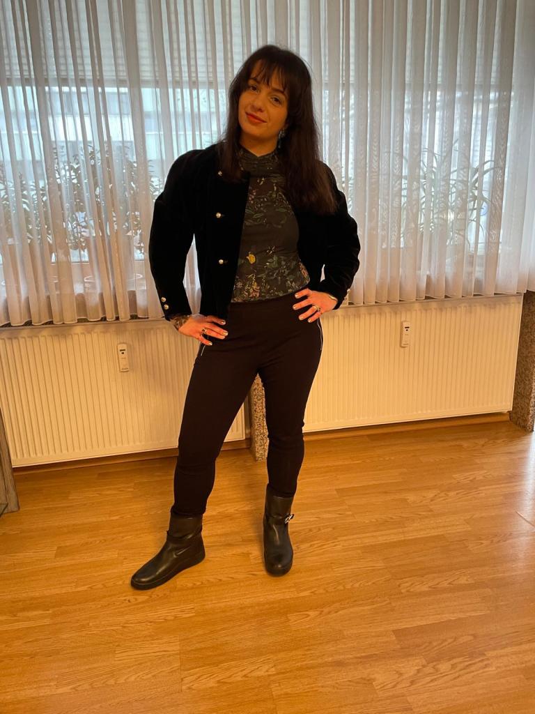 A basically black look based on the puffed shouldered blazer highlighted with green for the make-up trend.