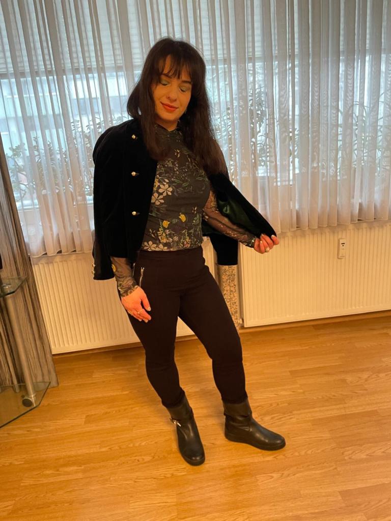 A basically black look based on the puffed shouldered blazer highlighted with green for the make-up trend.