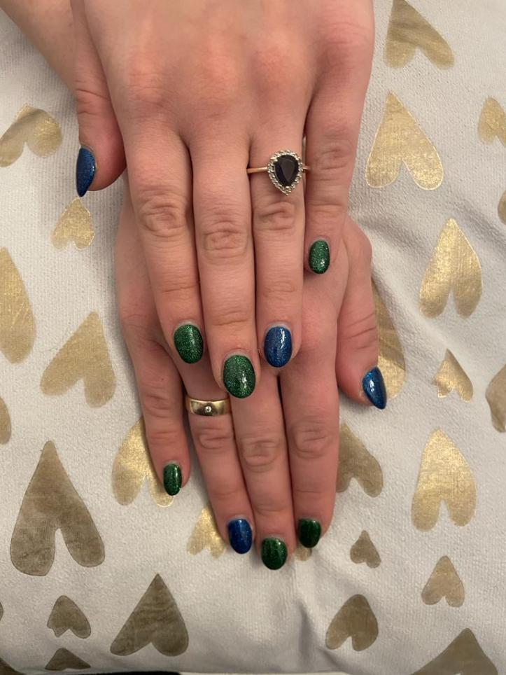 Glittery nails in blue and green.