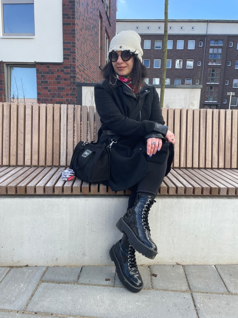 A robe-coat that looks like a dress, worn with winter-leggings, combat boots and sunglasses combined with beanies.