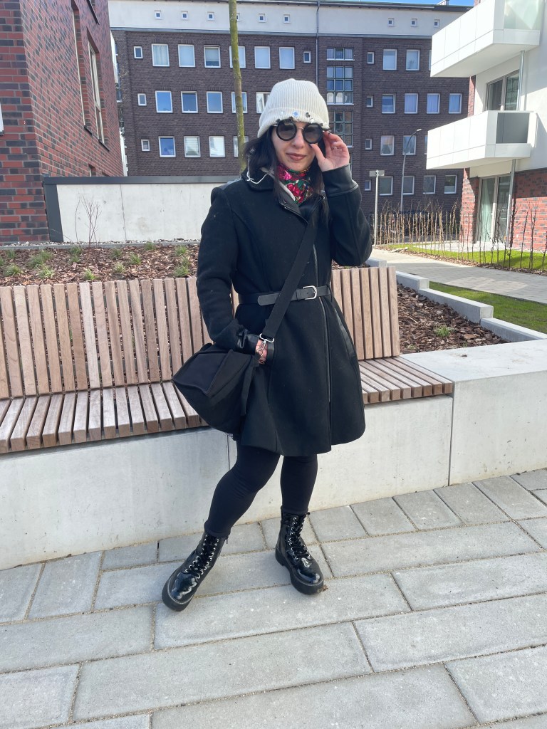 A robe-coat that looks like a dress, worn with winter-leggings, combat boots and sunglasses combined with beanies.