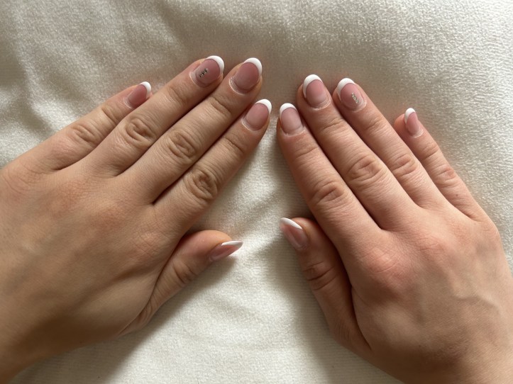 French nails with three stones on each ring-finger.