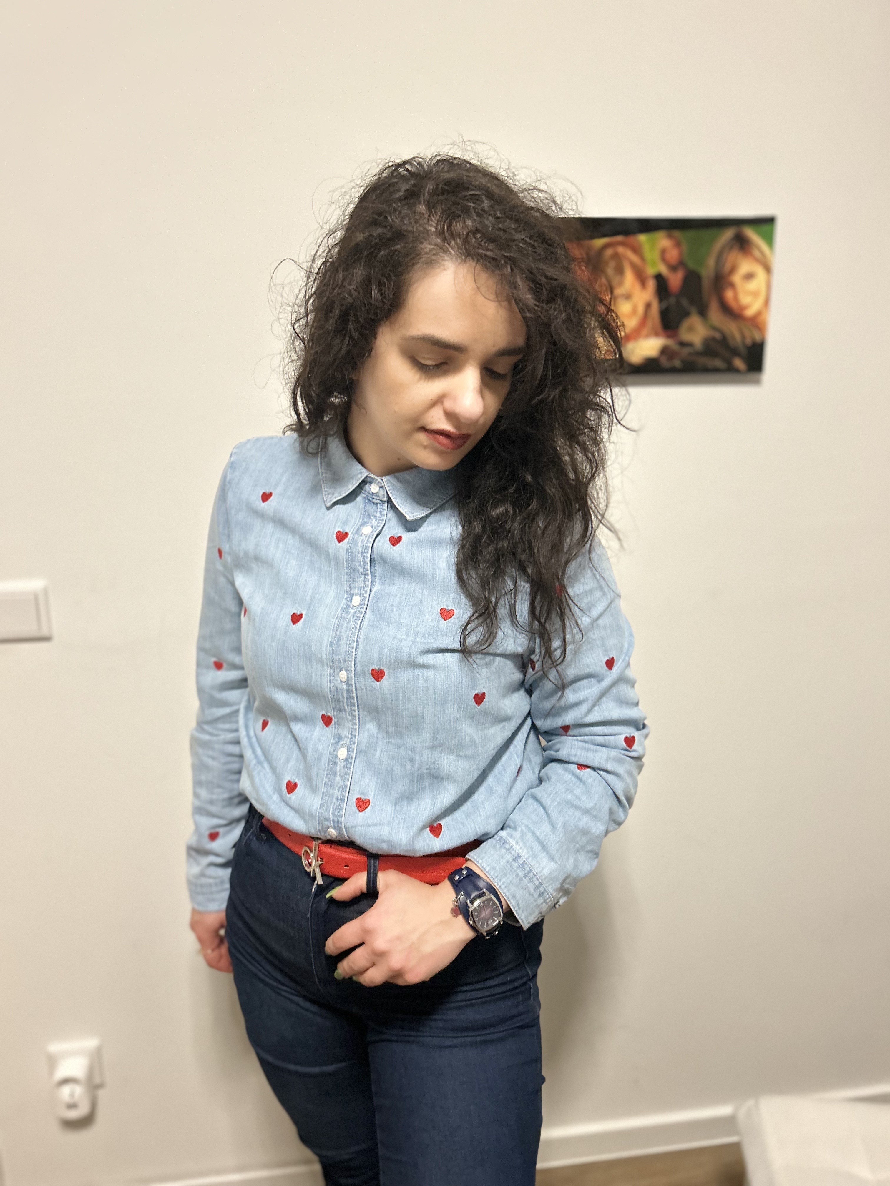 A cowgirl look denim on denim with red accents.