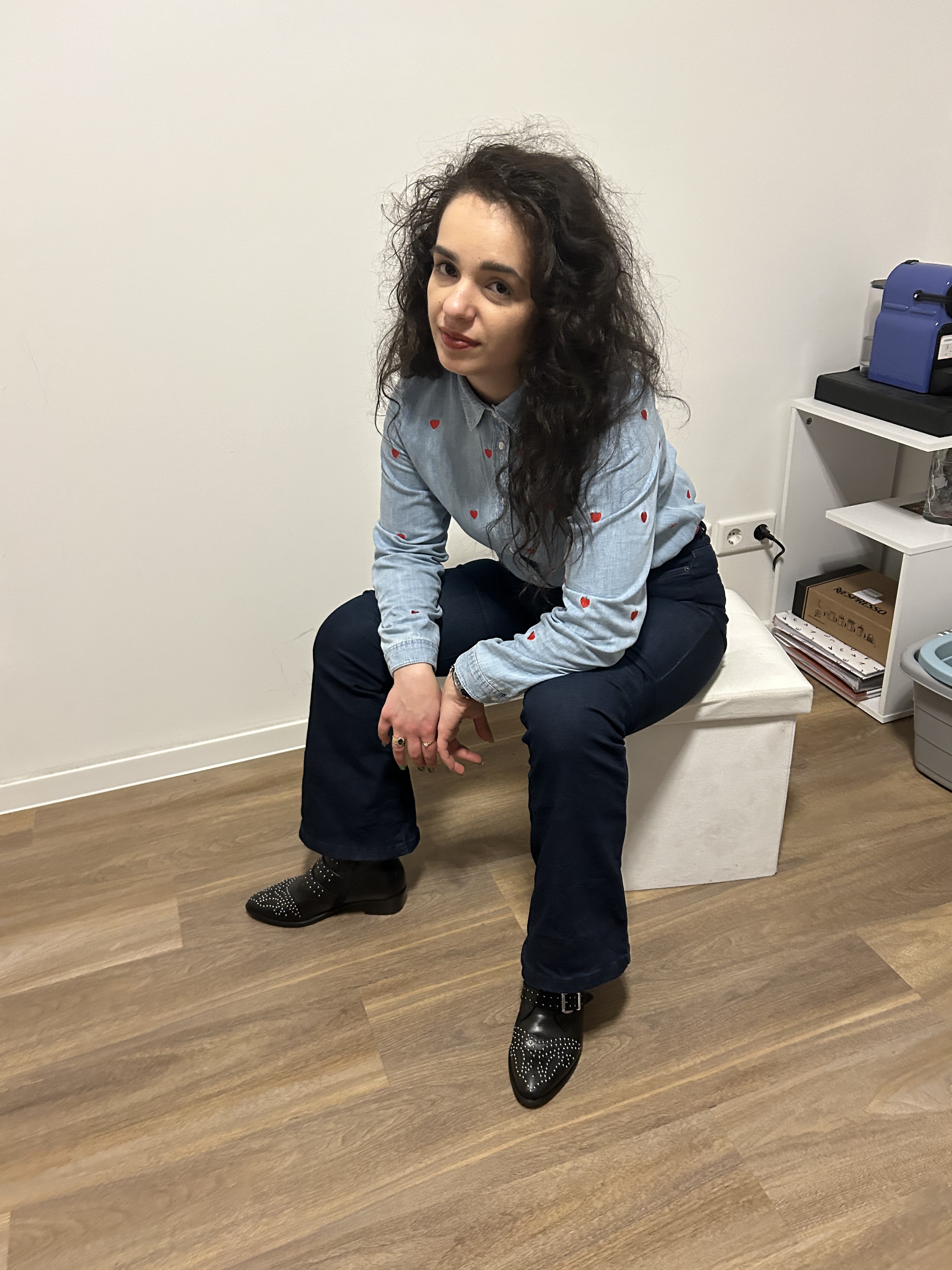 A cowgirl look denim on denim with red accents.